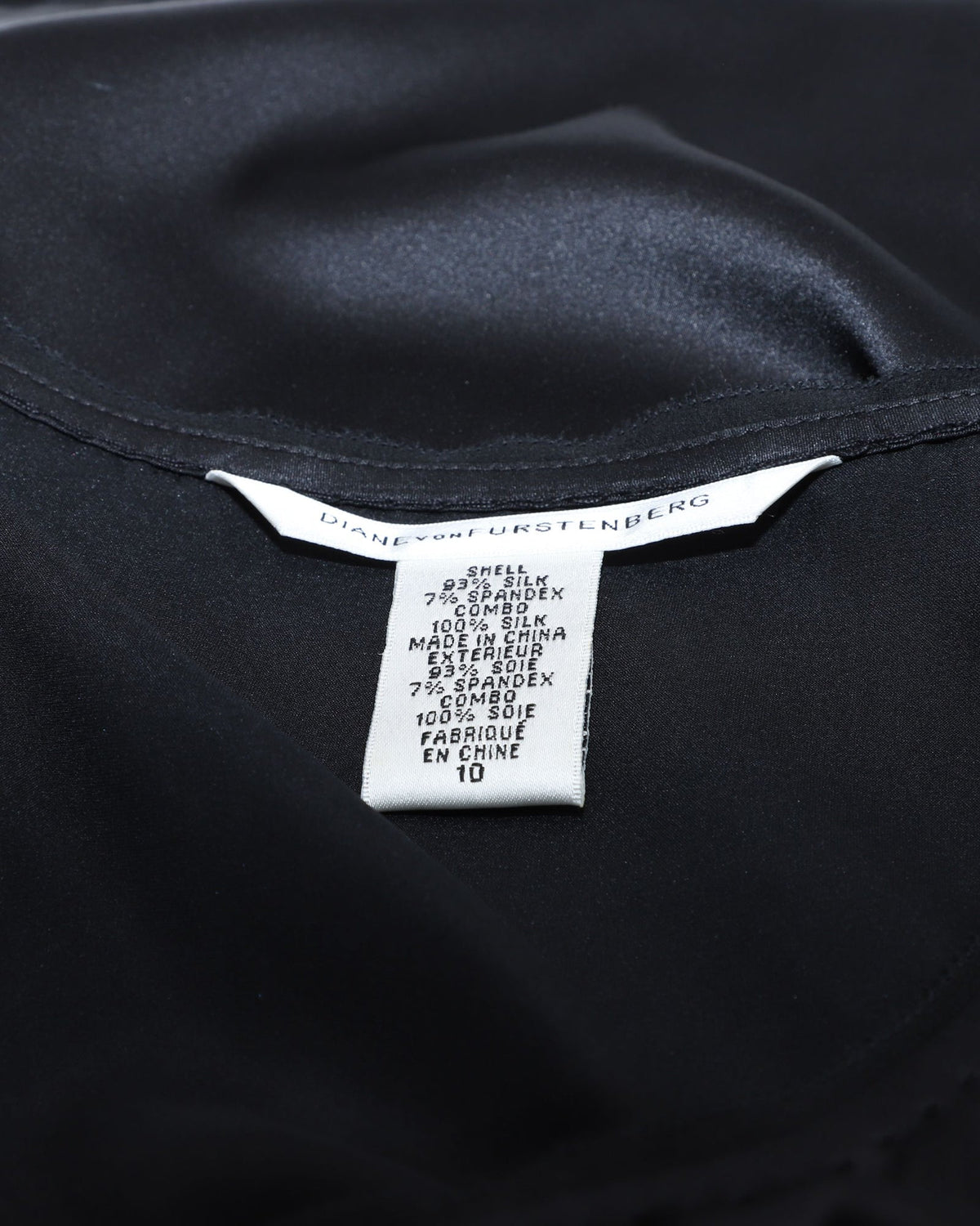 Blusa de seda sin mangas con boleros color negro